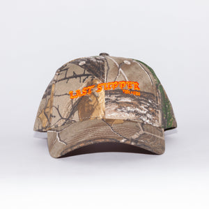 Last Supper Real Tree camo hat with orange logo and velcro back