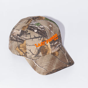 Last Supper Real Tree camo hat with orange logo and velcro back