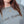 Person wearing a gray sweatshirt with 'Last Supper' text, close-up of face and upper body.